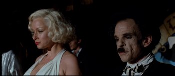 Movie still from “Mister Lonely” (2007), directed by Harmony Korine – A man and a woman are standing in a dark room; Close Up shot, Over the shoulder angle