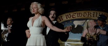 Movie still from “Mister Lonely” (2007), directed by Harmony Korine – A man and a woman in a white dress and a black suit; Medium shot, Low angle