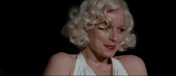 Movie still from “Mister Lonely” (2007), directed by Harmony Korine – A person with blonde hair; Close Up shot, Over the shoulder angle