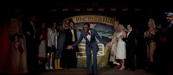 Movie still from “Mister Lonely” (2007), directed by Harmony Korine – A group of people standing on a stage; Wide shot, Low angle