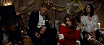 Movie still from “Mister Lonely” (2007), directed by Harmony Korine – A man and a woman sitting next to each other; Medium shot, High angle