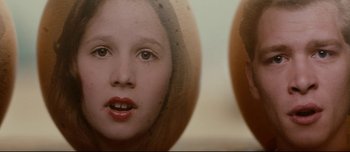 Movie still from “Mister Lonely” (2007), directed by Harmony Korine – A girl and a boy looking at each other in a mirror; Extreme Close Up shot, Overhead angle