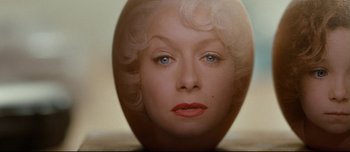 Movie still from “Mister Lonely” (2007), directed by Harmony Korine – A woman's face in a mirror; Extreme Close Up shot, Overhead angle