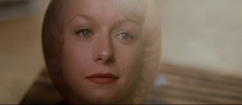 Movie still from “Mister Lonely” (2007), directed by Harmony Korine – A woman's face in a mirror; Extreme Close Up shot, Overhead angle