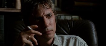 Movie still from “Mister Lonely” (2007), directed by Harmony Korine – A person smoking a cigarette; Close Up shot, Low angle