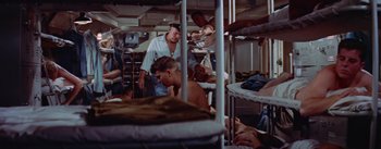 Movie still from “Mister Roberts” (1955), directed by John Ford – A group of people in a room with bunk beds; Wide shot, High angle