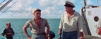 Movie still from “Mister Roberts” (1955), directed by John Ford – Two men on a boat in front of the ocean; Medium shot, High angle