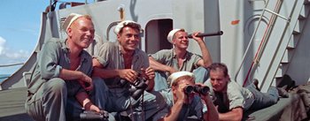 Movie still from “Mister Roberts” (1955), directed by John Ford – A group of men sitting on top of a boat; Medium shot, High angle