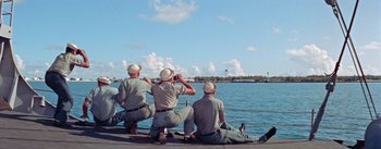 Movie still from “Mister Roberts” (1955), directed by John Ford – A group of men sitting on top of a boat; Wide shot, Low angle