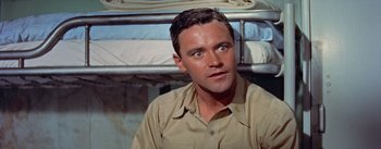 Movie still from “Mister Roberts” (1955), directed by John Ford – A person sitting in a room; Close Up shot, High angle