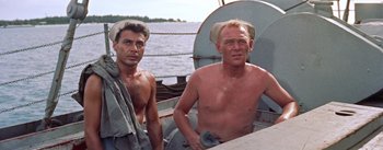Movie still from “Mister Roberts” (1955), directed by John Ford – Two shirtless men sitting on a sailboat in the water; Medium shot, High angle