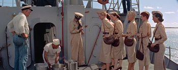 Movie still from “Mister Roberts” (1955), directed by John Ford – A group of women standing next to each other on a boat; Wide shot, High angle