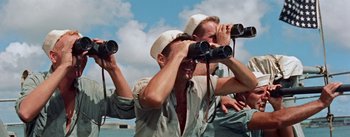 Movie still from “Mister Roberts” (1955), directed by John Ford – A group of men standing next to each other on top of a boat; Medium shot, High angle