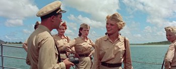 Movie still from “Mister Roberts” (1955), directed by John Ford – A group of people in uniform standing next to each other; Medium shot, Low angle