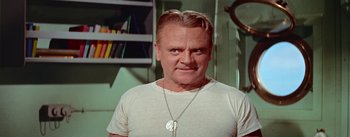 Movie still from “Mister Roberts” (1955), directed by John Ford – A person wearing a white t shirt; Close Up shot, Low angle