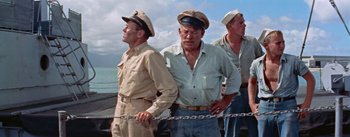 Movie still from “Mister Roberts” (1955), directed by John Ford – A group of men standing next to each other on a boat; Medium shot, Low angle