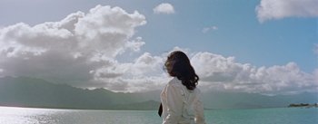 Movie still from “Mister Roberts” (1955), directed by John Ford – A woman in a white shirt looking out at the ocean; Extreme Wide shot, Low angle