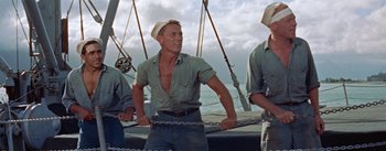 Movie still from “Mister Roberts” (1955), directed by John Ford – A group of men standing next to each other on top of a boat; Medium shot, Low angle