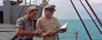 Movie still from “Mister Roberts” (1955), directed by John Ford – Two men on a boat looking at a map; Medium shot, High angle