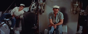 Movie still from “Mister Roberts” (1955), directed by John Ford – A man sitting on the floor in front of a wall; Medium shot, High angle