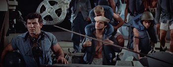 Movie still from “Mister Roberts” (1955), directed by John Ford – A man with a hat and a rope around his neck; Medium shot, High angle