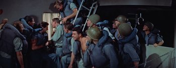 Movie still from “Mister Roberts” (1955), directed by John Ford – A group of men in blue shirts and helmets; Medium shot, High angle