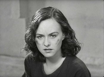 Movie still from “Modern Times” (1936), directed by Charles Chaplin – Black and white photograph of a young woman in a t - shirt; Close Up shot, High angle