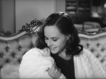 Movie still from “Modern Times” (1936), directed by Charles Chaplin – A woman holding a baby in her arms and smiling; Close Up shot, High angle