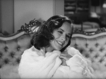 Movie still from “Modern Times” (1936), directed by Charles Chaplin – A woman sitting on top of a couch holding a cat; Close Up shot, High angle