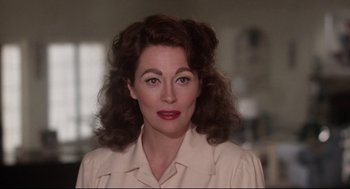 Movie still from “Mommie Dearest” (1981), directed by Frank Perry – A person wearing a dress shirt; Close Up shot, Over the shoulder angle
