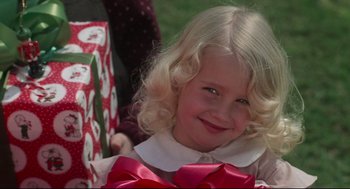 Movie still from “Mommie Dearest” (1981), directed by Frank Perry – A little girl with blonde hair and a red bow; Close Up shot, Over the shoulder angle