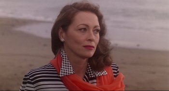 Movie still from “Mommie Dearest” (1981), directed by Frank Perry – A person wearing a striped shirt; Close Up shot, Over the shoulder angle