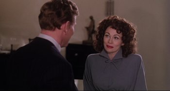Movie still from “Mommie Dearest” (1981), directed by Frank Perry – A man and a woman talking to each other; Close Up shot, Over the shoulder angle