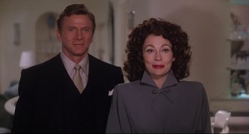 Movie still from “Mommie Dearest” (1981), directed by Frank Perry – A man and a woman standing next to each other; Medium shot, Low angle