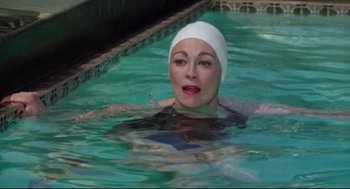 Movie still from “Mommie Dearest” (1981), directed by Frank Perry – A woman in a swimming pool wearing a white hat; Close Up shot, High angle