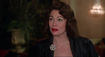 Movie still from “Mommie Dearest” (1981), directed by Frank Perry – A person wearing a jacket; Close Up shot, Over the shoulder angle