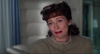 Movie still from “Mommie Dearest” (1981), directed by Frank Perry – An older woman with red lipstick looking at the camera; Close Up shot, Over the shoulder angle