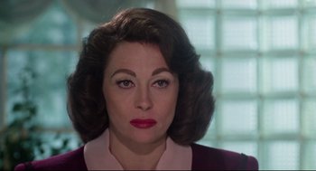 Movie still from “Mommie Dearest” (1981), directed by Frank Perry – A person wearing a dress; Close Up shot, Over the shoulder angle