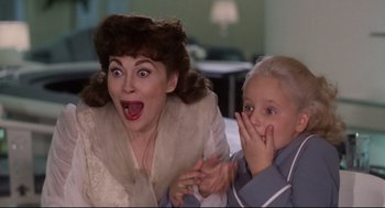 Movie still from “Mommie Dearest” (1981), directed by Frank Perry – A woman and a little girl sitting next to each other; Close Up shot, High angle