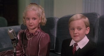Movie still from “Mommie Dearest” (1981), directed by Frank Perry – Two young children dressed up in formal attire; Close Up shot, High angle