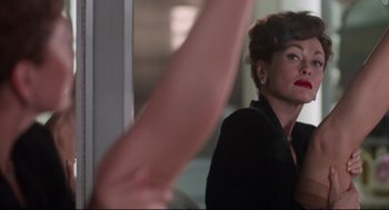 Movie still from “Mommie Dearest” (1981), directed by Frank Perry – A person holding a hand up; Close Up shot, Over the shoulder angle