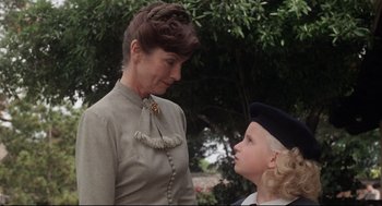Movie still from “Mommie Dearest” (1981), directed by Frank Perry – An older woman and a young girl looking at each other; Close Up shot, Over the shoulder angle
