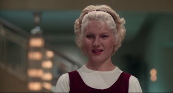 Movie still from “Mommie Dearest” (1981), directed by Frank Perry – A woman with blonde hair wearing a red and white dress; Close Up shot, Low angle