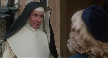 Movie still from “Mommie Dearest” (1981), directed by Frank Perry – A woman dressed as a nun talking to another woman; Close Up shot, Over the shoulder angle