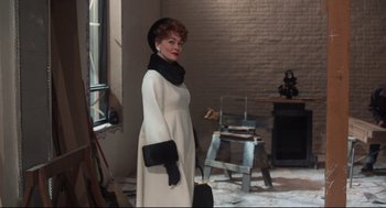 Movie still from “Mommie Dearest” (1981), directed by Frank Perry – An older woman in a white dress and black hat; Medium shot, Over the shoulder angle