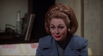 Movie still from “Mommie Dearest” (1981), directed by Frank Perry – A person wearing a coat; Close Up shot, Over the shoulder angle