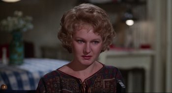 Movie still from “Mommie Dearest” (1981), directed by Frank Perry – A person wearing a dress; Close Up shot, Over the shoulder angle