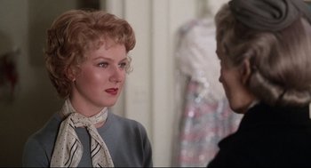 Movie still from “Mommie Dearest” (1981), directed by Frank Perry – A woman wearing a neck tie talking to another woman; Close Up shot, Over the shoulder angle