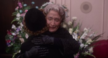 Movie still from “Mommie Dearest” (1981), directed by Frank Perry – An older woman is hugging a younger woman; Medium shot, Over the shoulder angle