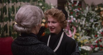Movie still from “Mommie Dearest” (1981), directed by Frank Perry – A woman talking to another woman wearing a black jacket; Close Up shot, Over the shoulder angle